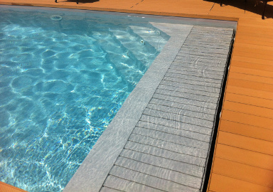 servizio piscina chiavi in mano: piscina con tapparella e deck in legno ricostruito